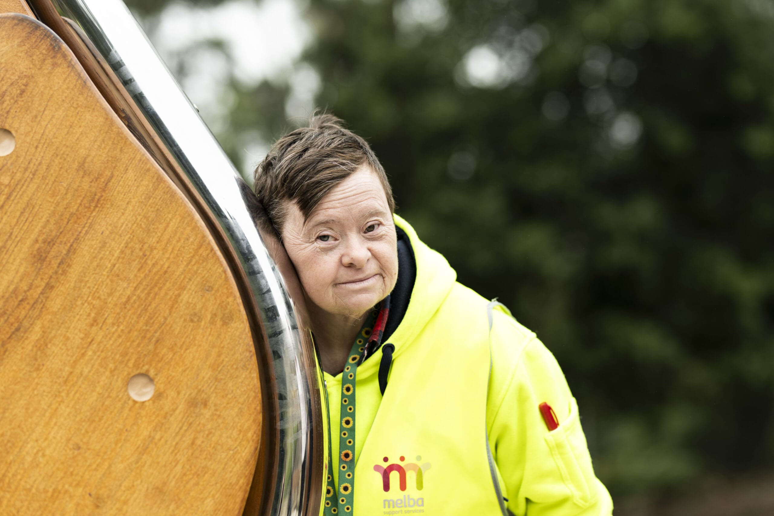 A person listens to the harmonic device sculpture that is park of Regeneration - The Listening Place, an accessible artwork along ngurrak barring.